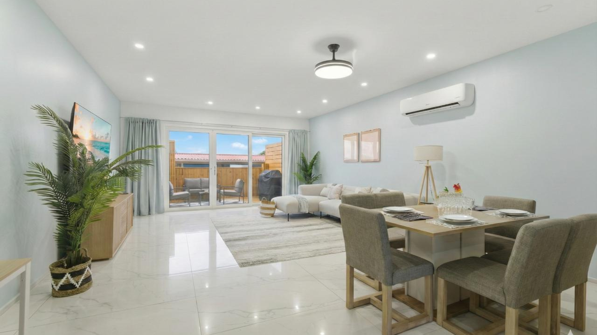 Relax in this airy living room with plush sectional and serene décor