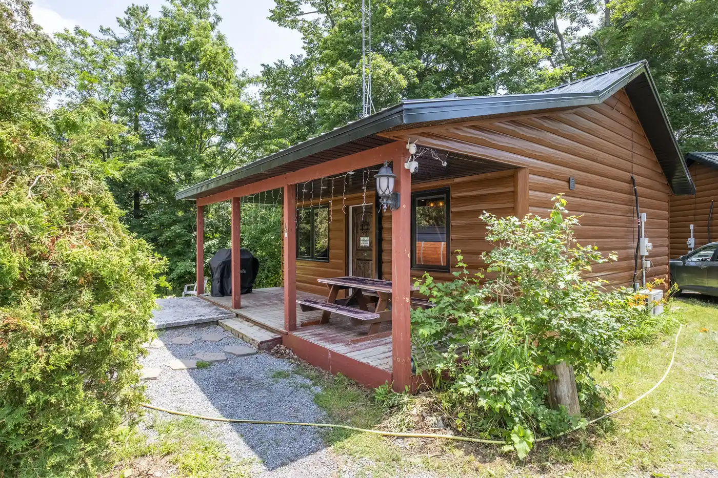 Front exterior of Cottage #4 surrounded by mature greenery