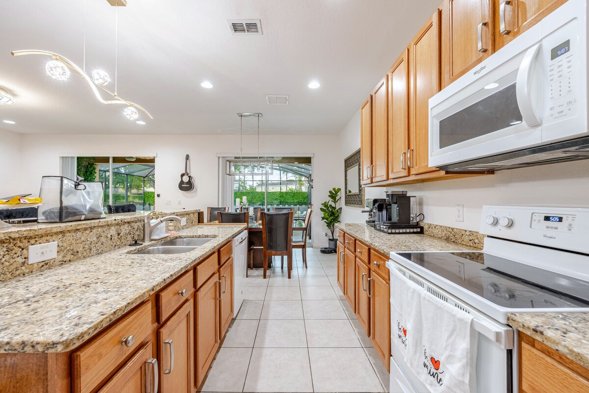 Cook and bake with a KitchenAid stand mixer, mixing bowls, cookware and large serving platters—all while enjoying your favorite cooking show on the nearby 98-inch TV.