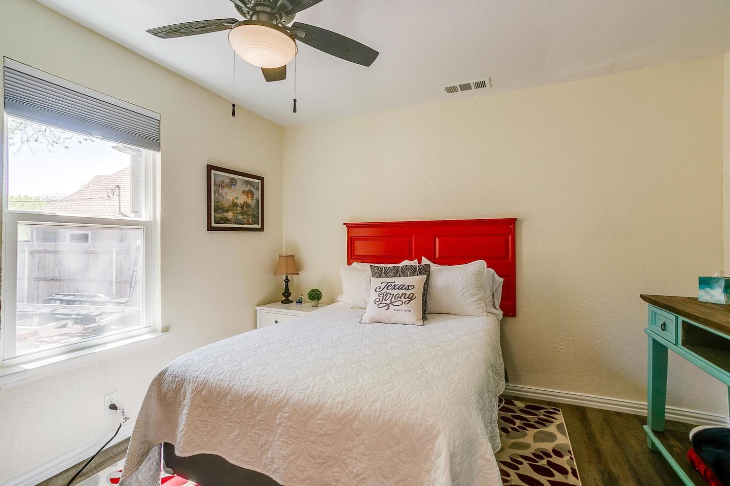 Queen bedroom with room-darkening shades and Smart TV for restful, relaxing lakefront stays.