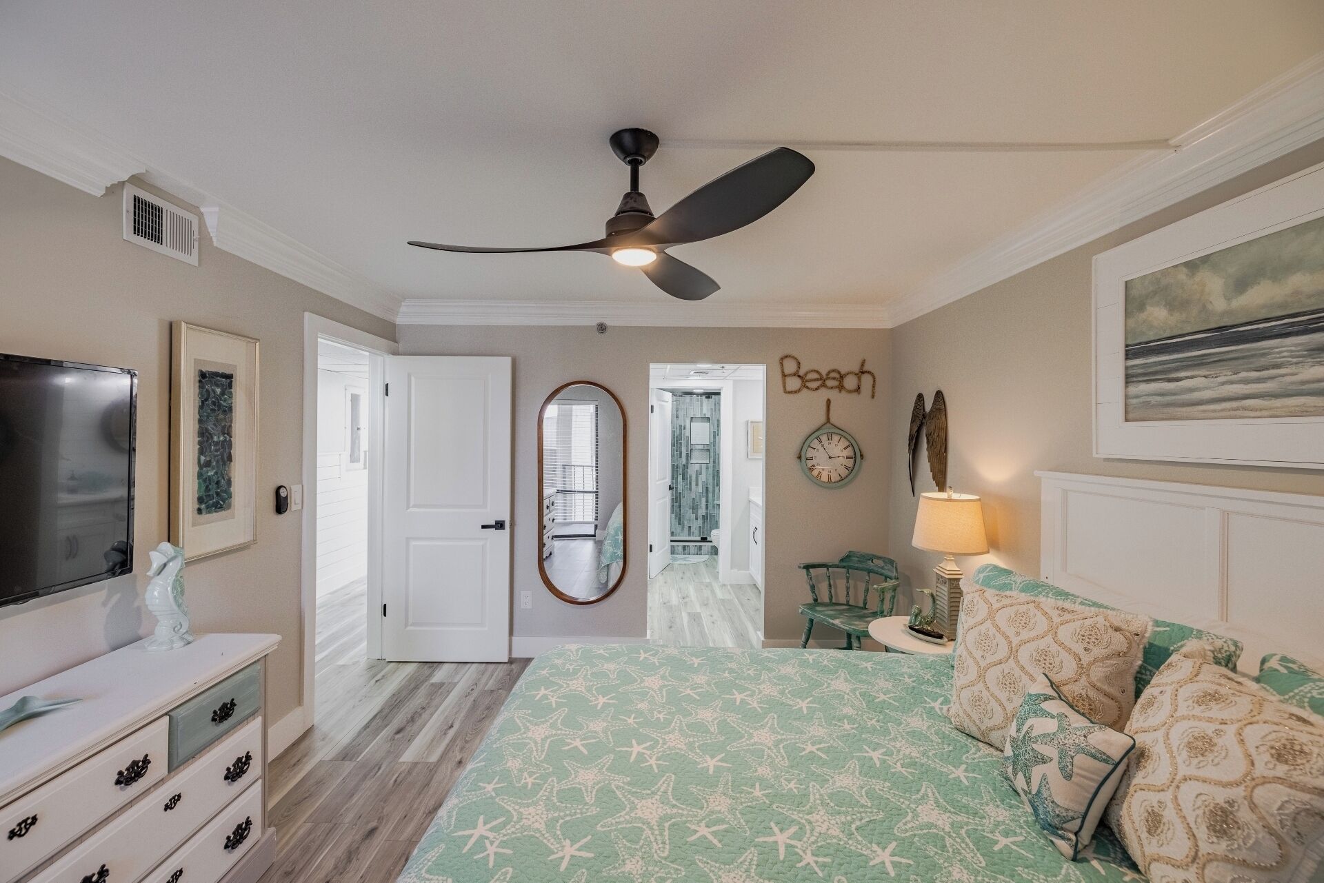 Master bedroom with king bed, ceiling fan, smart TV and ensuite bathroom
