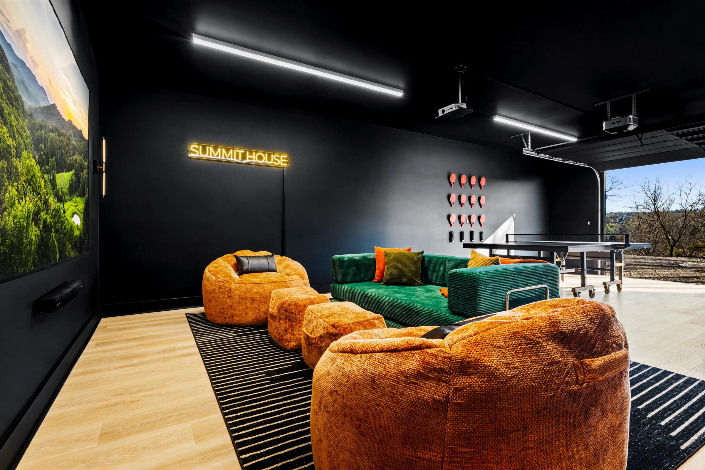 {Theater + Lounge} Open the garage door, pour a drink, and settle in — ping pong matches, music playing, conversations that turn into late-night memories.