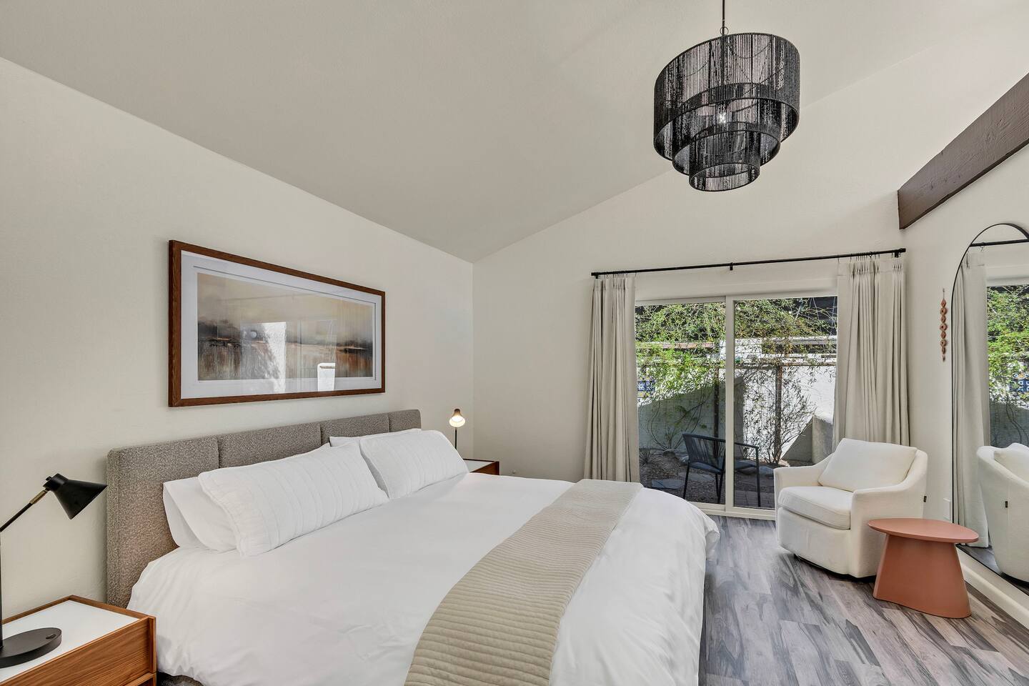 King bed and seating area in master bedroom.