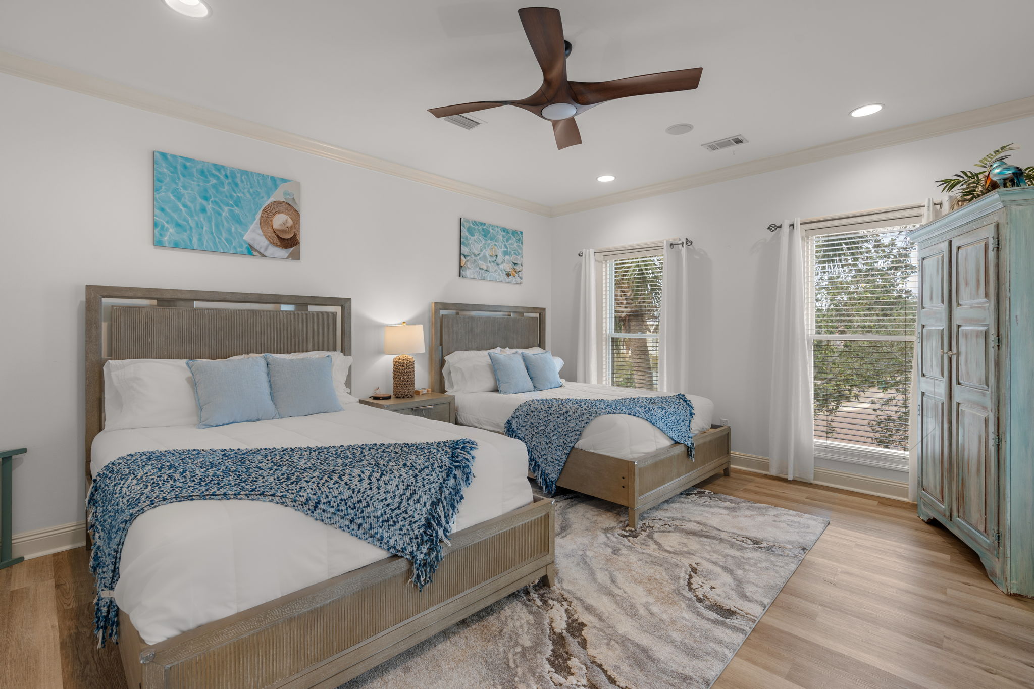 The guest bedroom on the second floor features two comfortable queen beds