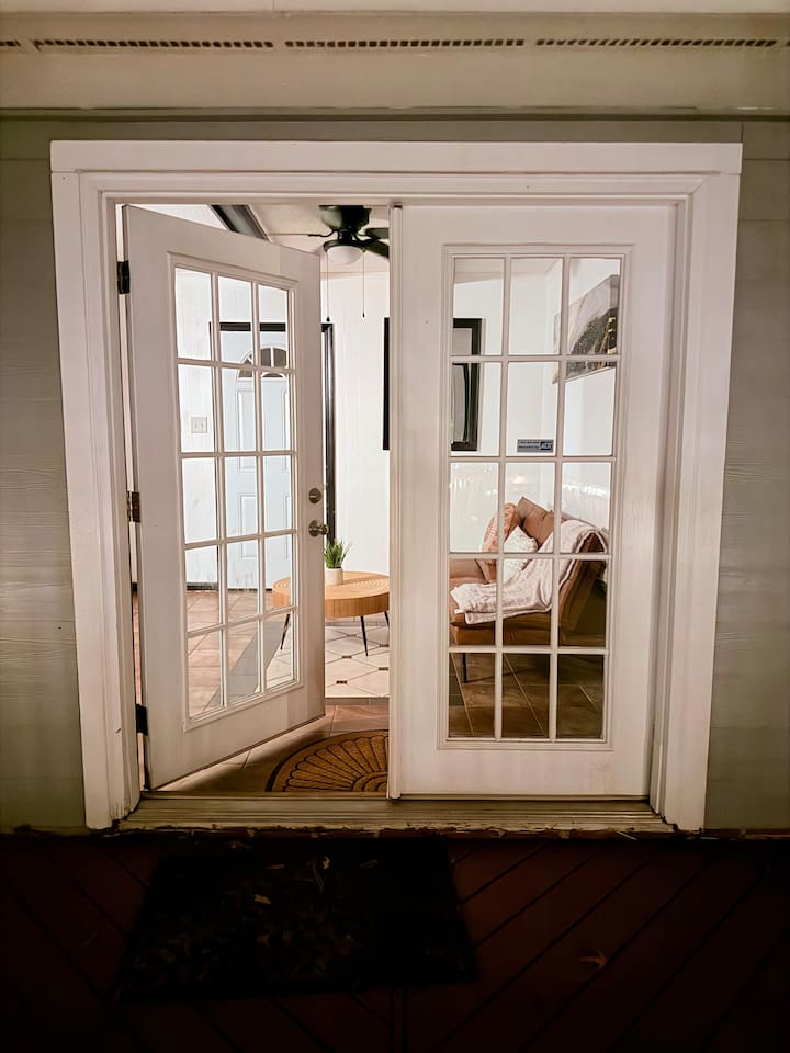 French doors open into a bright common area, adding charm and flexible space to this thoughtfully designed home.