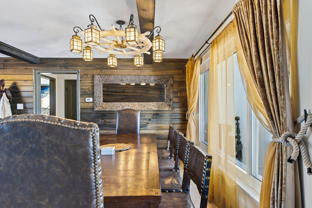 Council of Captains – The grand dining table awaits, flanked by antique chairs salvaged from a Spanish monastery. Even without a feast set, the room whispers of history, legends, and gathering