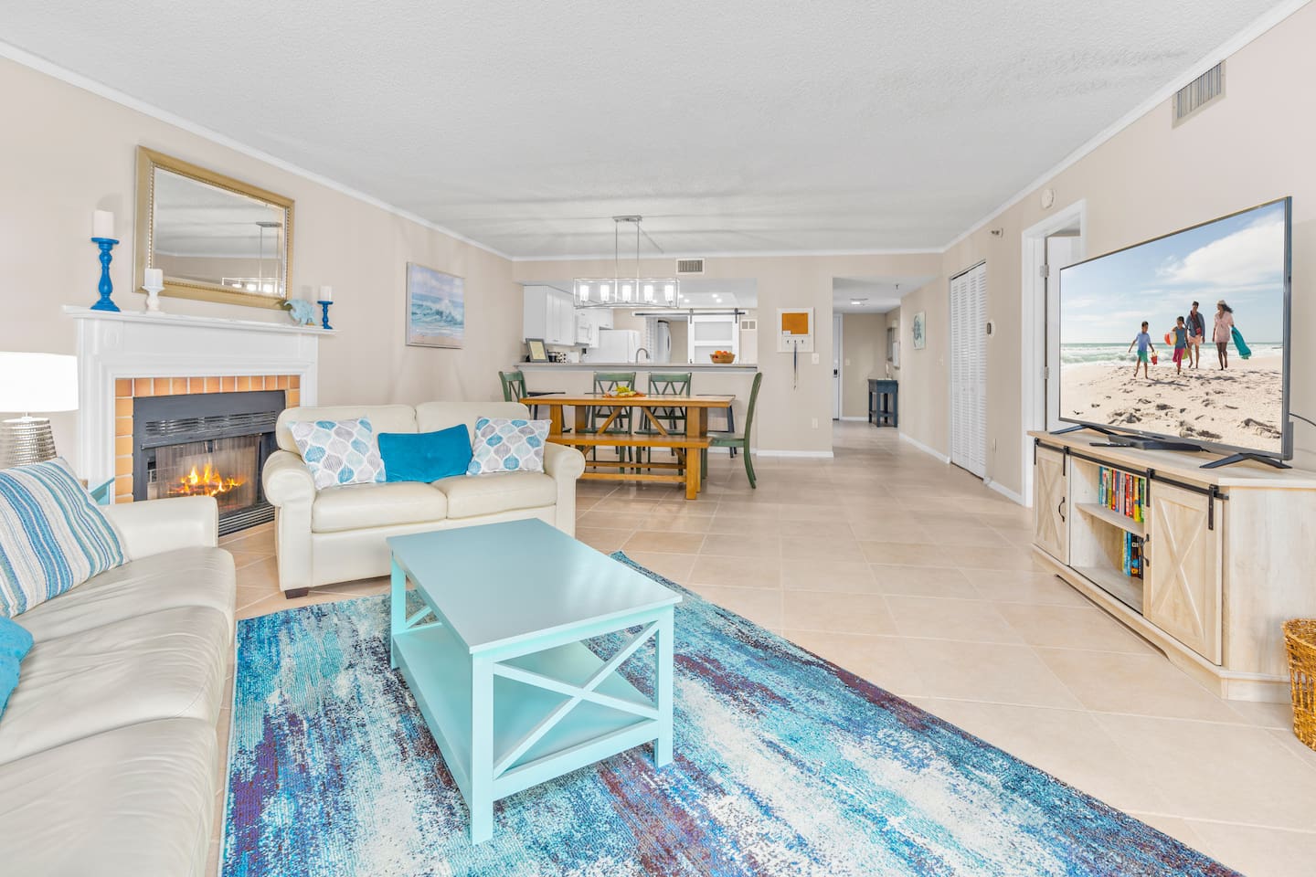 Huge open cozy living room with 70-inch LED Smart TV, Fireplace and Gulf Views