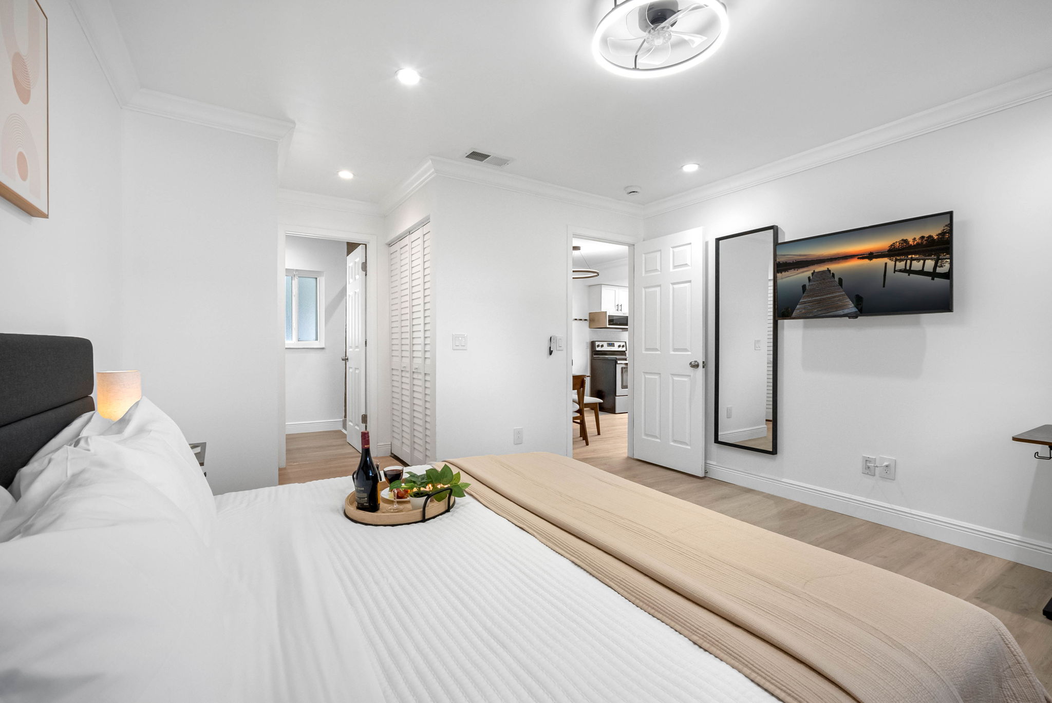 Enjoy movie nights from bed with the wall-mounted smart TV and blackout curtains for the ultimate binge-worthy setup.