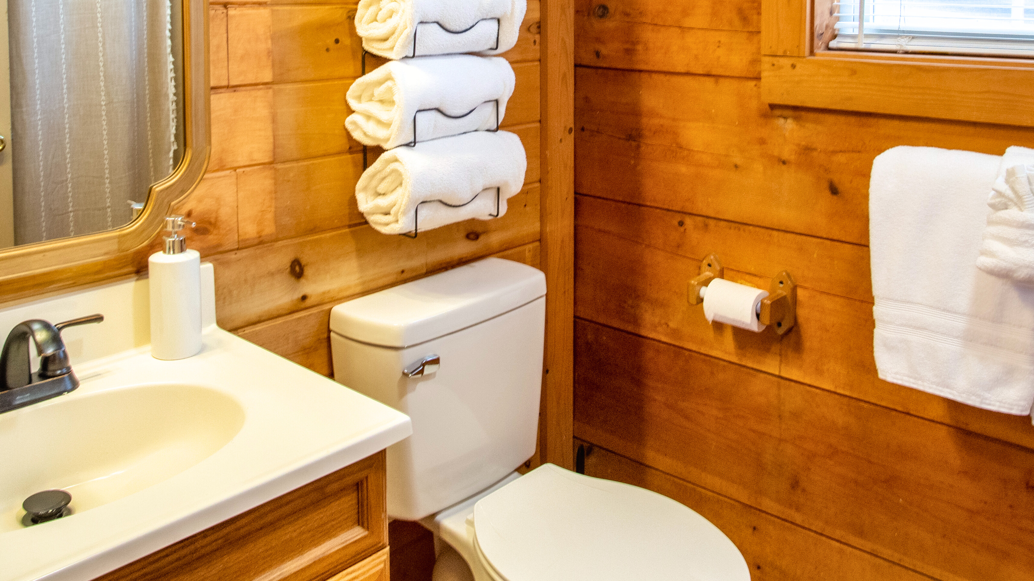 Bright, clean bathroom with fresh towels and a full shower/tub combo