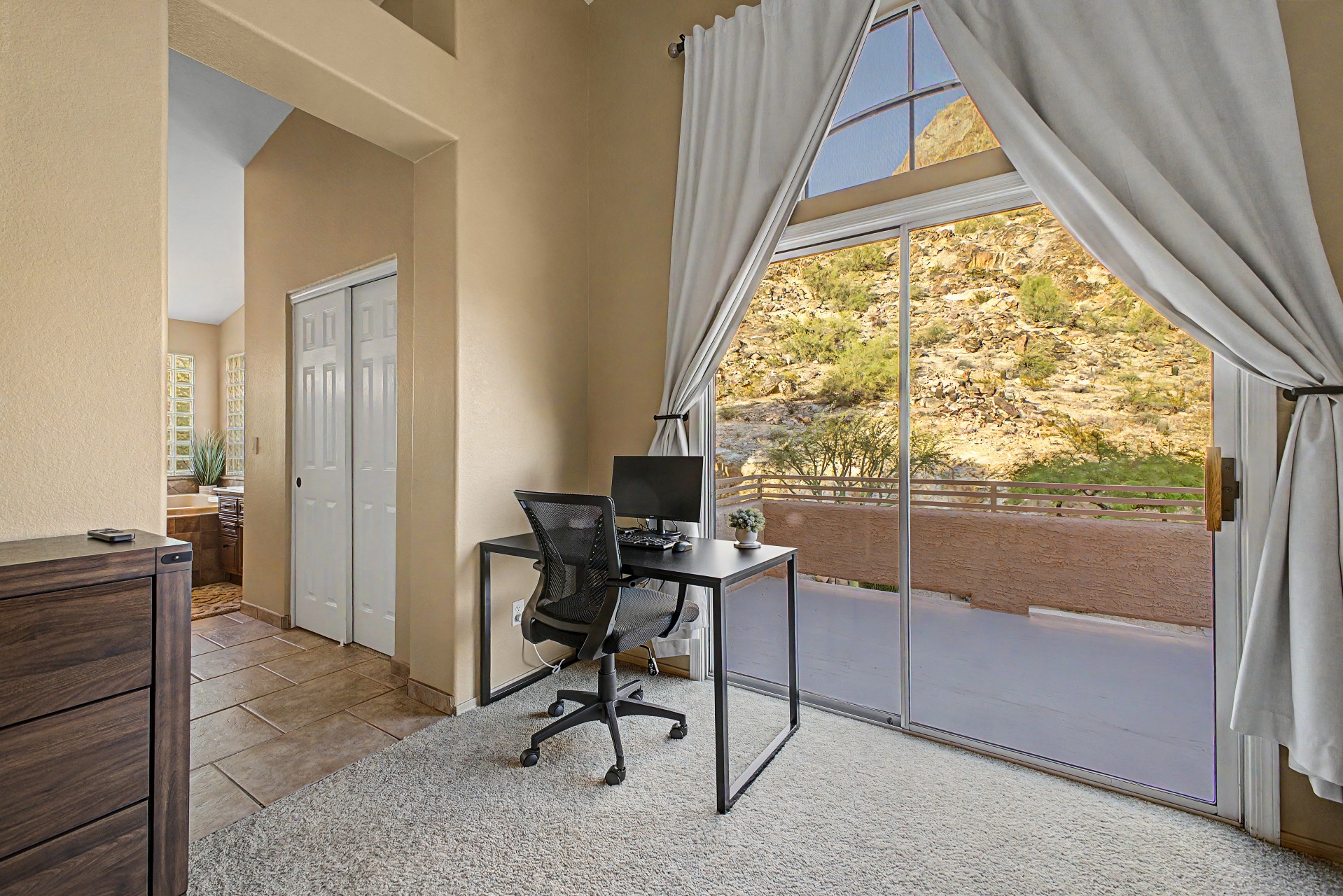 Primary Bedroom: Stunning views paired with a sleek workspace—your perfect retreat awaits!