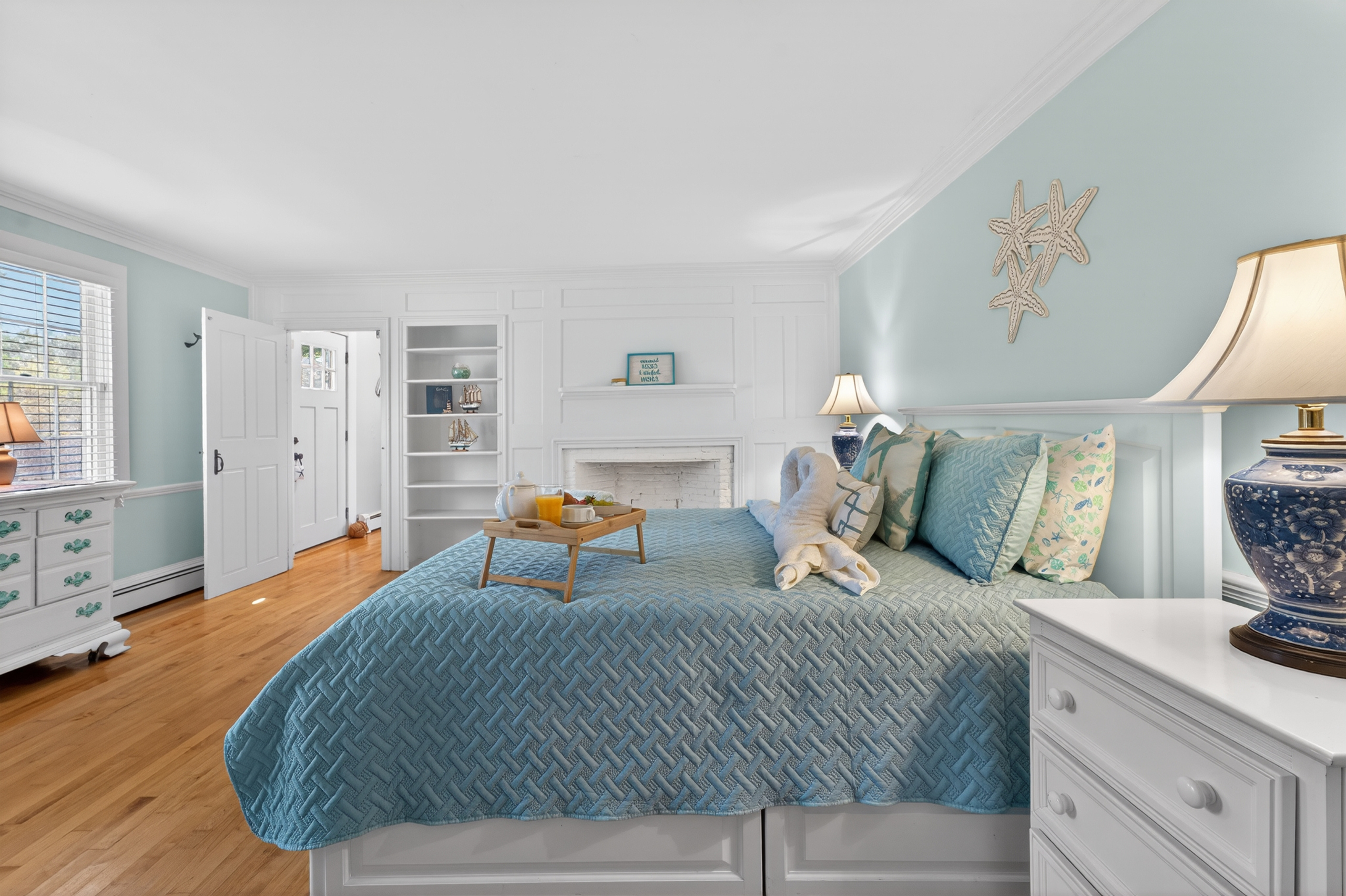 Spacious primary bedroom featuring a coastal décor, and plenty of room to unwind.