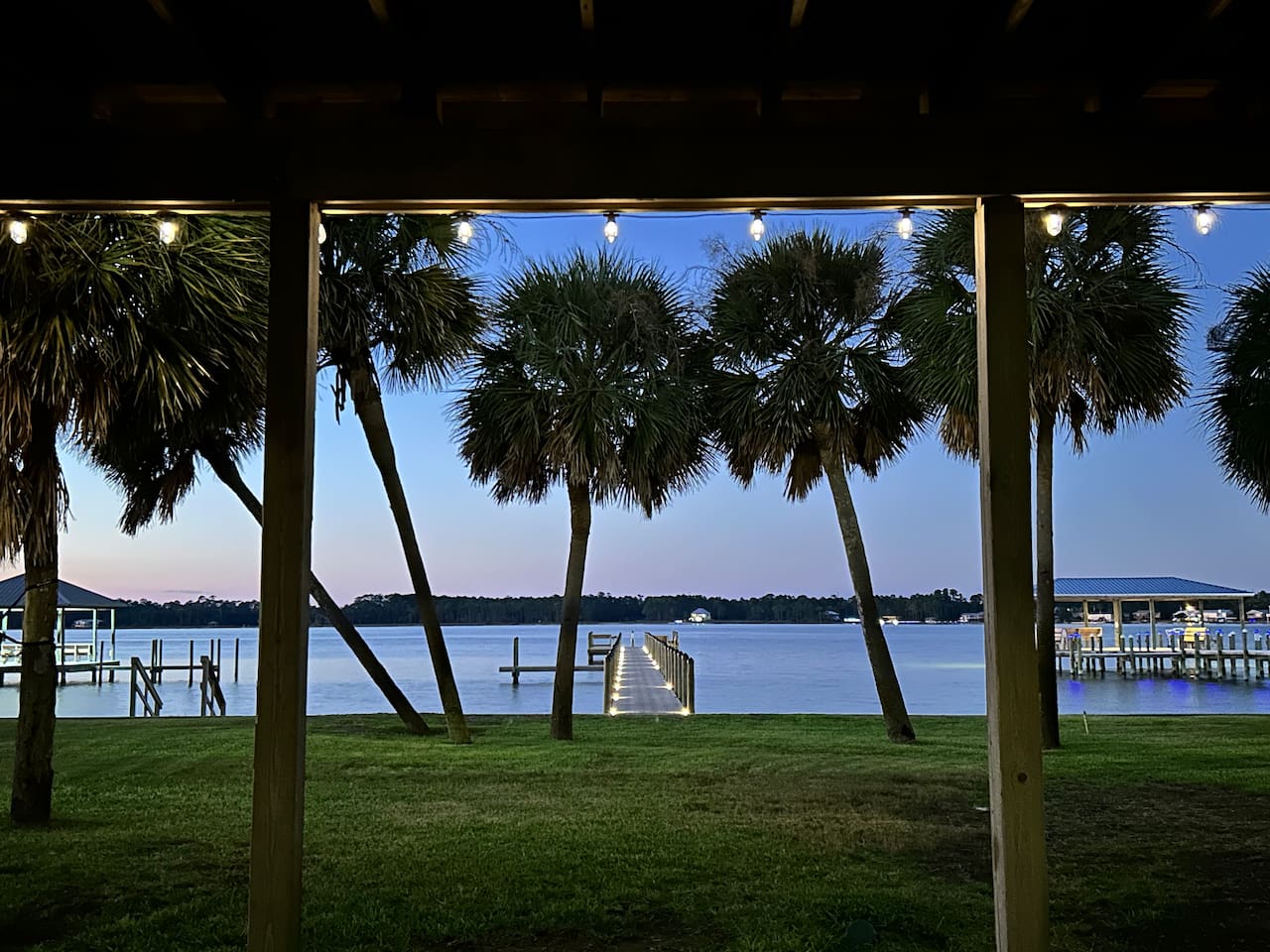 Twilight tranquility by the lake with palm trees, serene water, and cozy vibes.