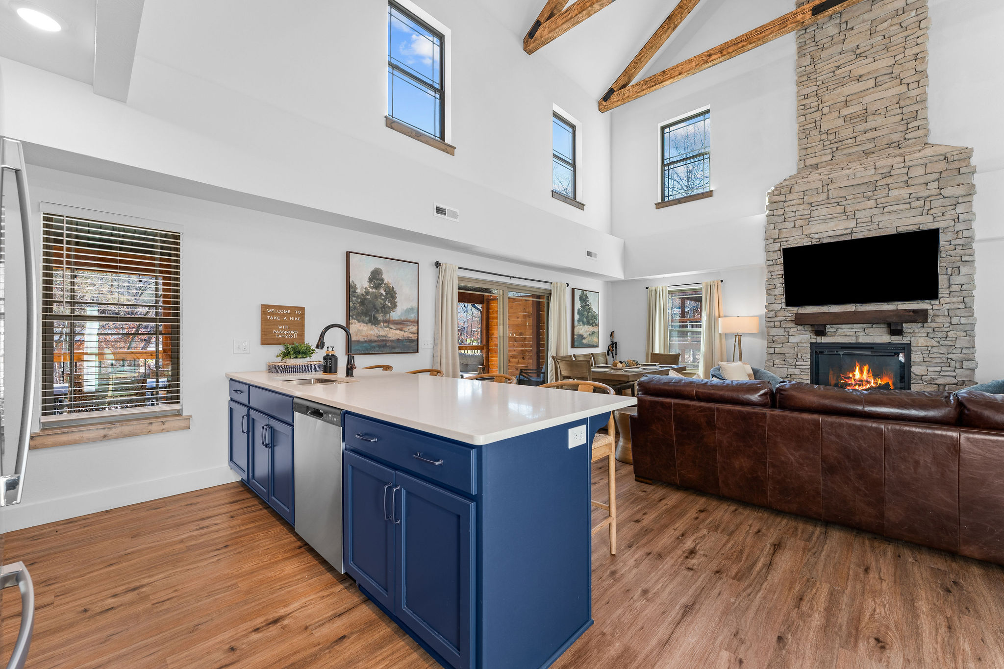 Bright kitchen island view overlooking the living space and fireplace.
