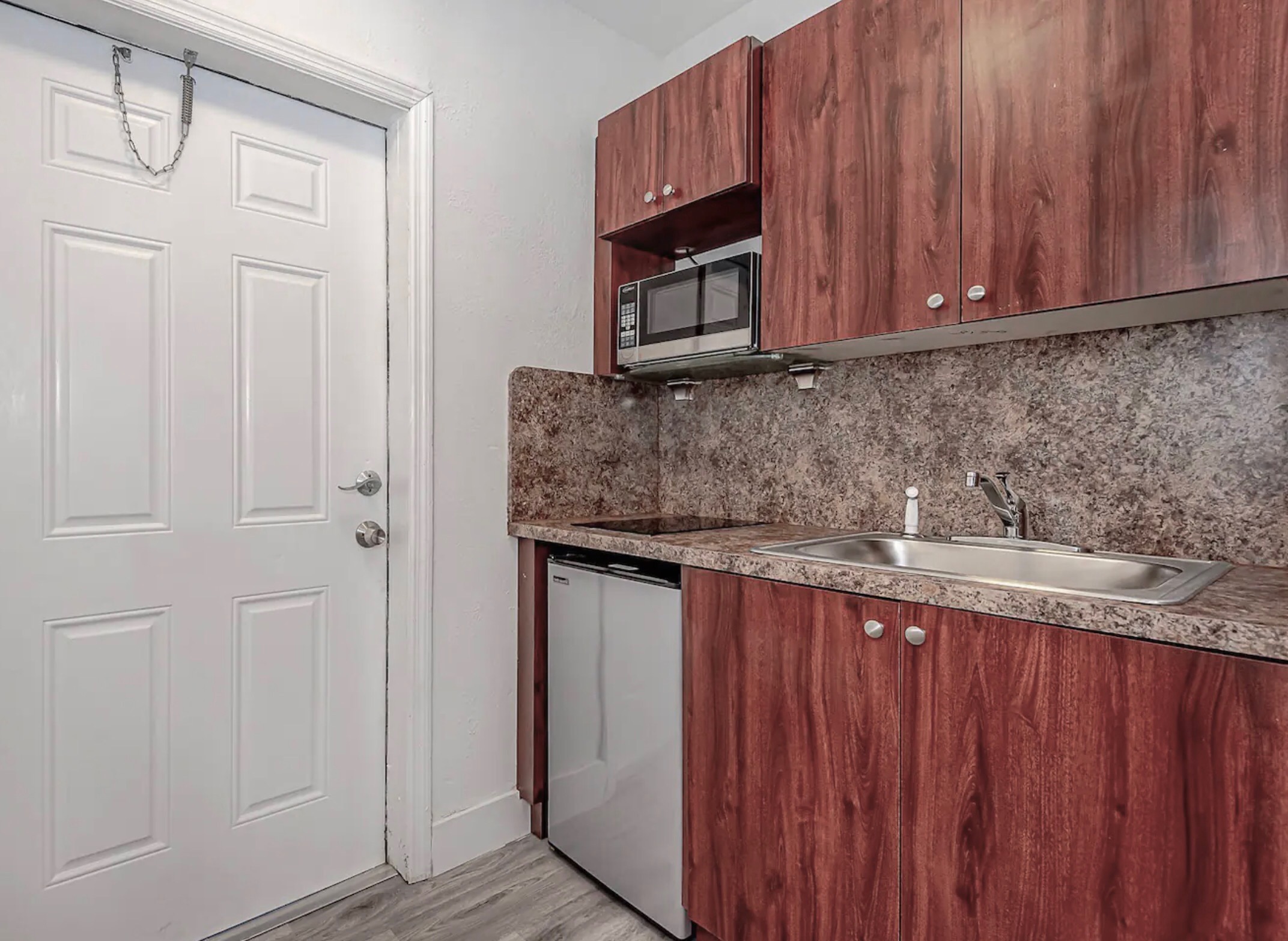Kitchenette with cooktop, microwave, and mini-fridge for your basic cooking needs.