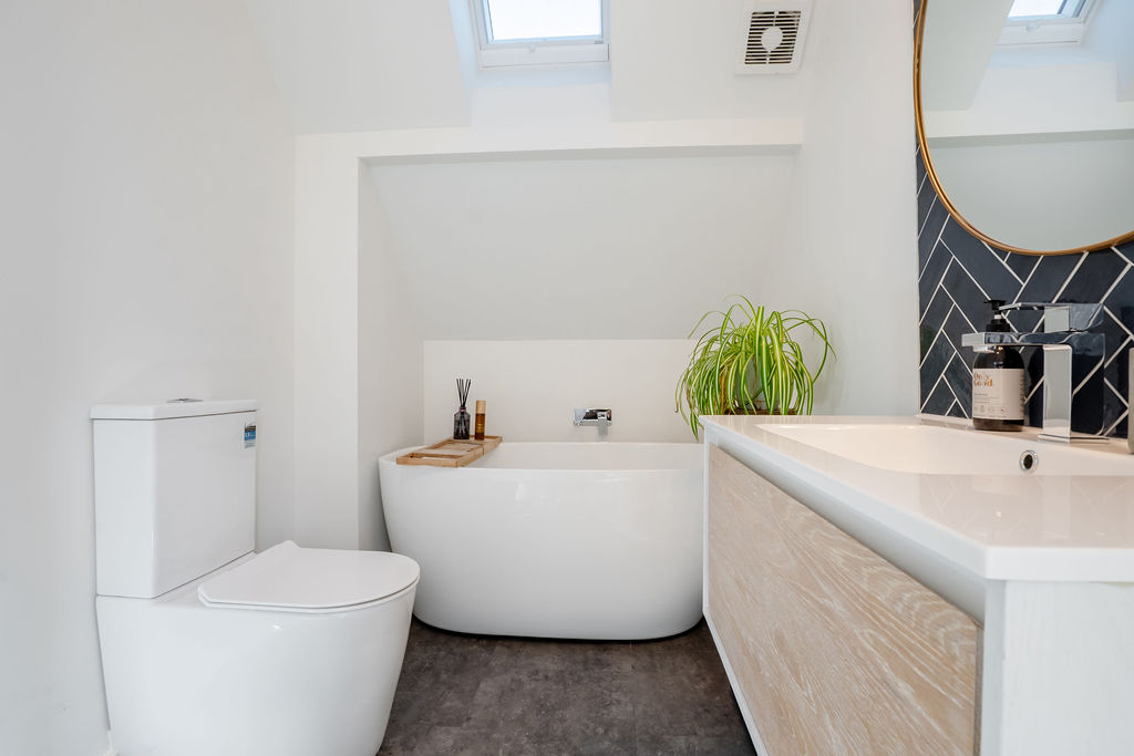 Skylights above the bath bring natural light into this upstairs bathroom, giving the space a bright alpine feel at Fernhill Mountain Escape.