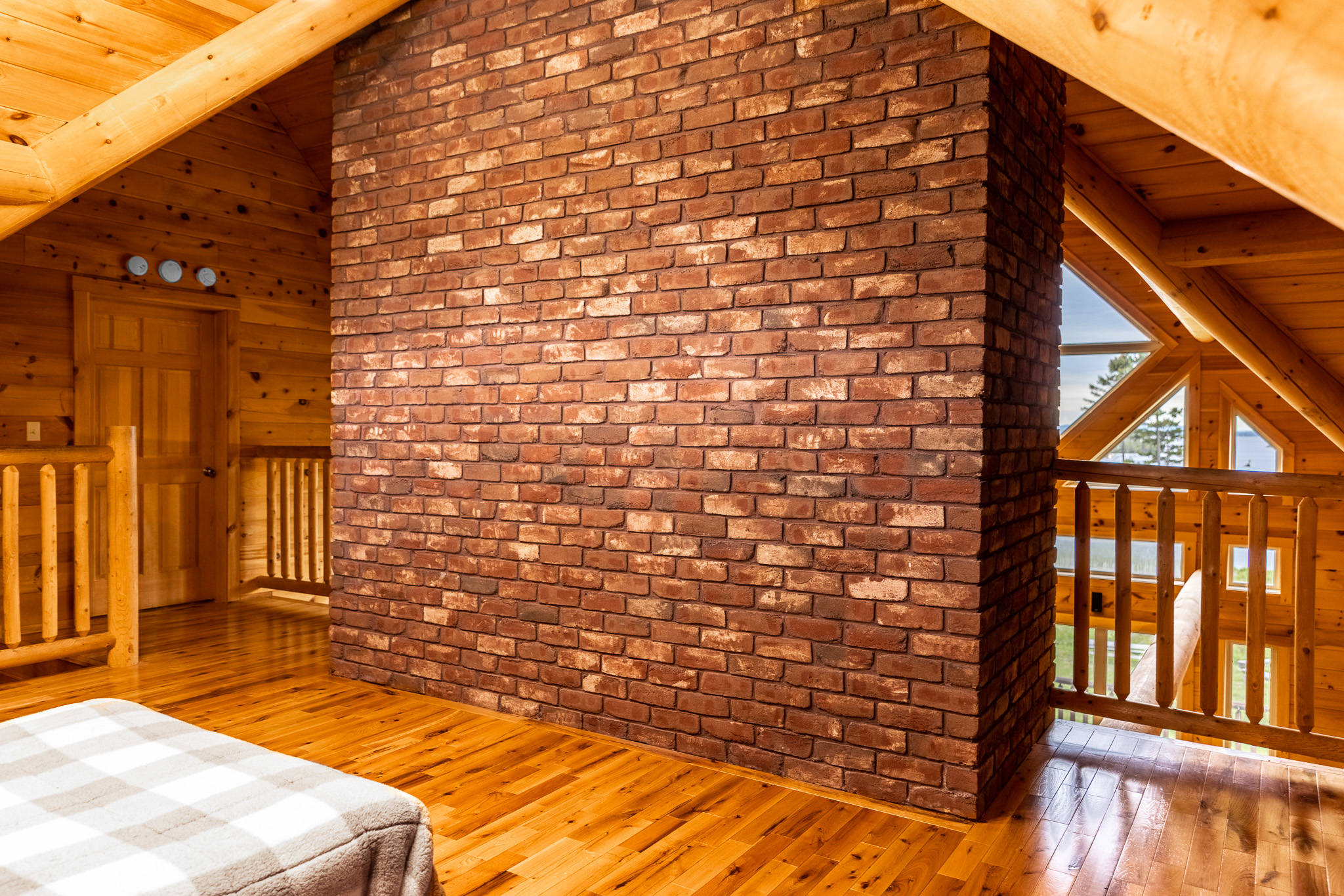 Loft with full bed hidden on top floor behind the huge fireplace. Great spot for kids to sleep while still keeping an eye on them.