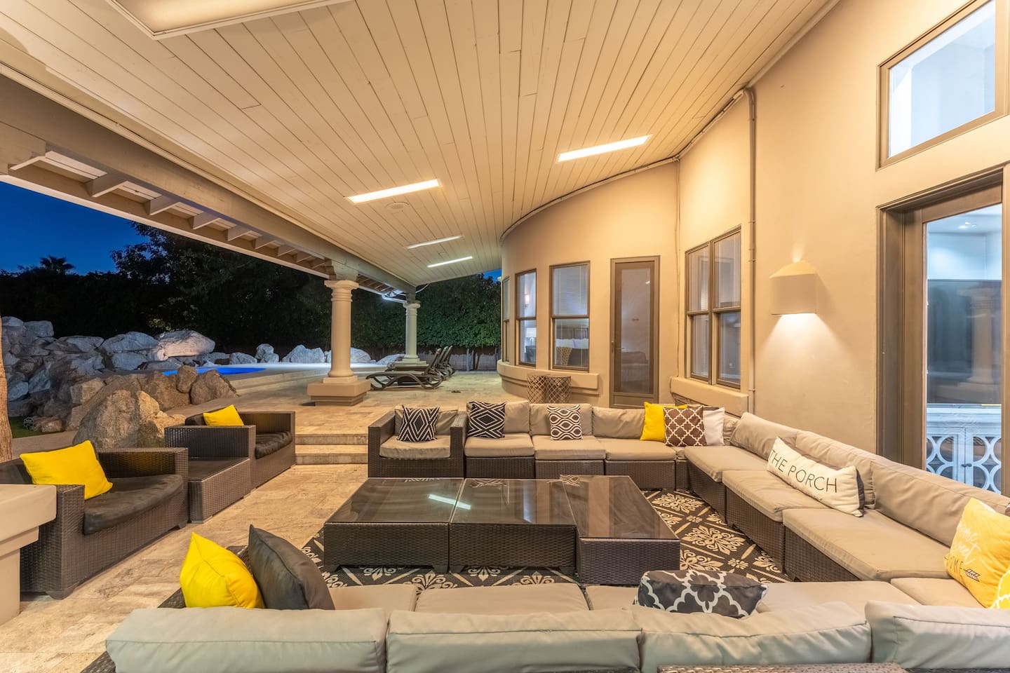 Relax in style on this oversized sectional with plush cushions and warm lighting, perfect for any gathering.