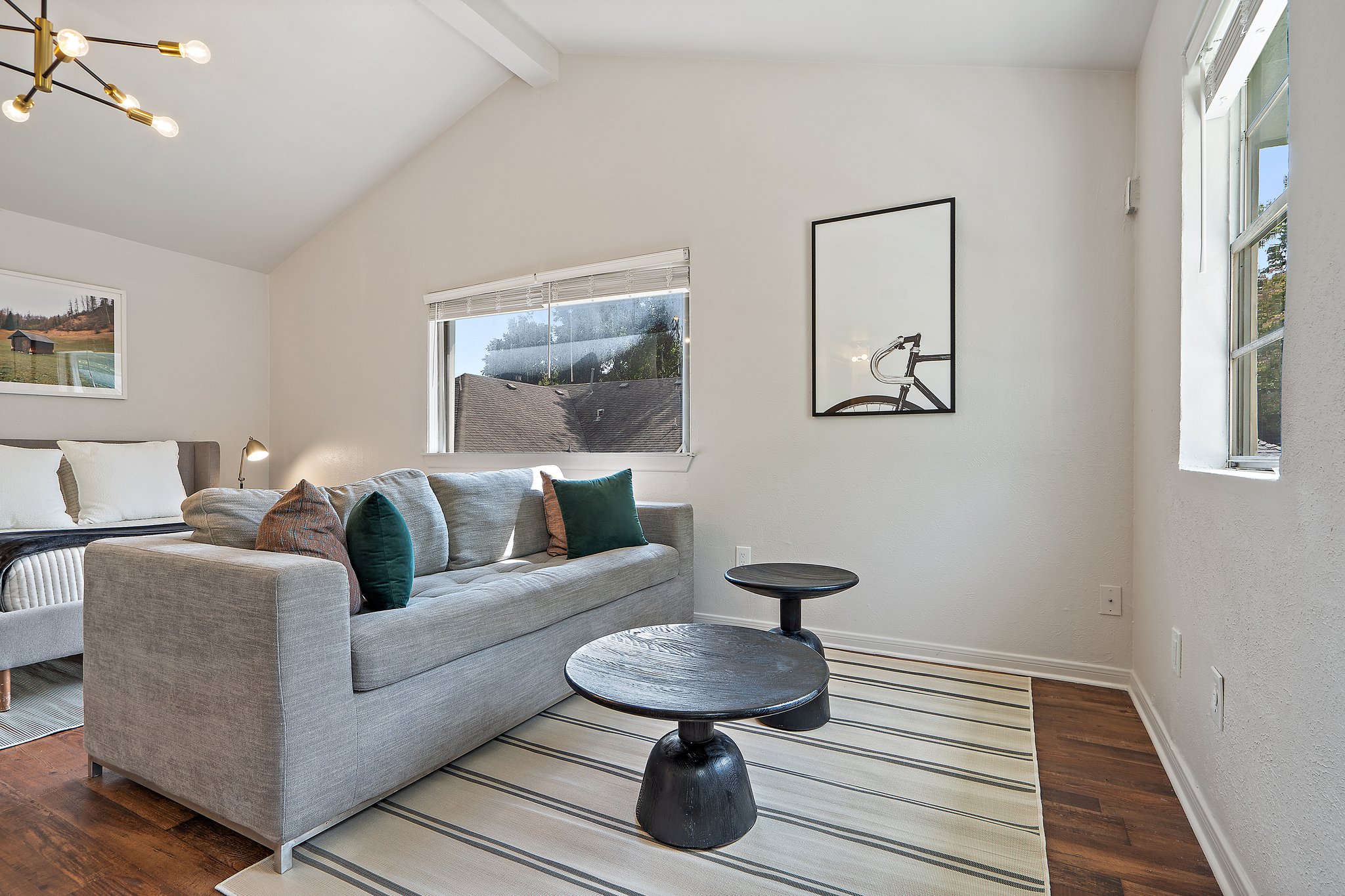 Detached Studio lounge seating / sleeper sofa with curated artwork and statement lighting. 65-inch Smart TV with streaming, high-speed Wi-Fi, central AC and heat, and Keurig coffee maker. Fully self-contained unit.