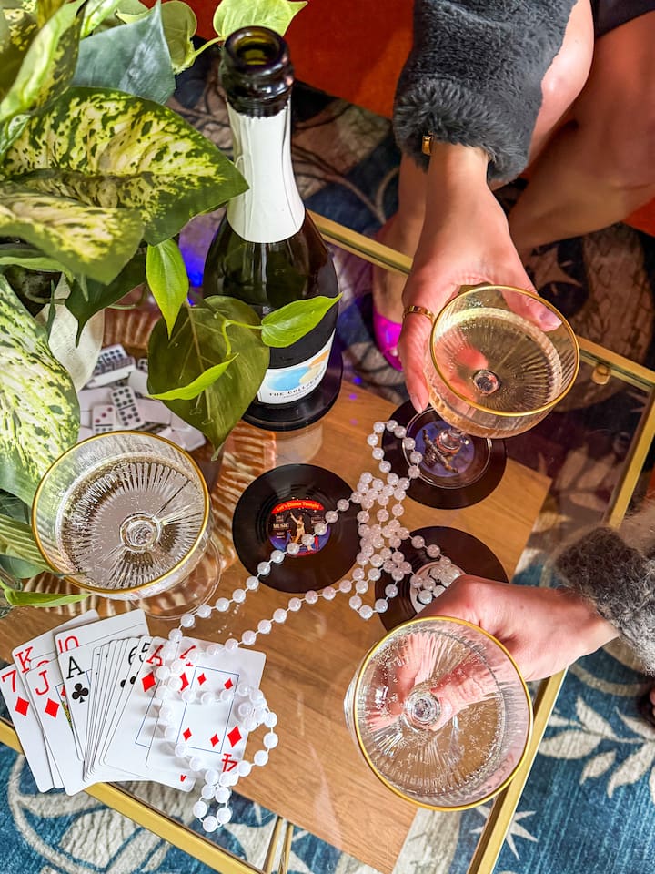 Champagne, vintage glassware, and game night vibes in this stylish New Orleans Airbnb.  The perfect setting for celebrations, girls trips, and unforgettable weekends near the French Quarter. 