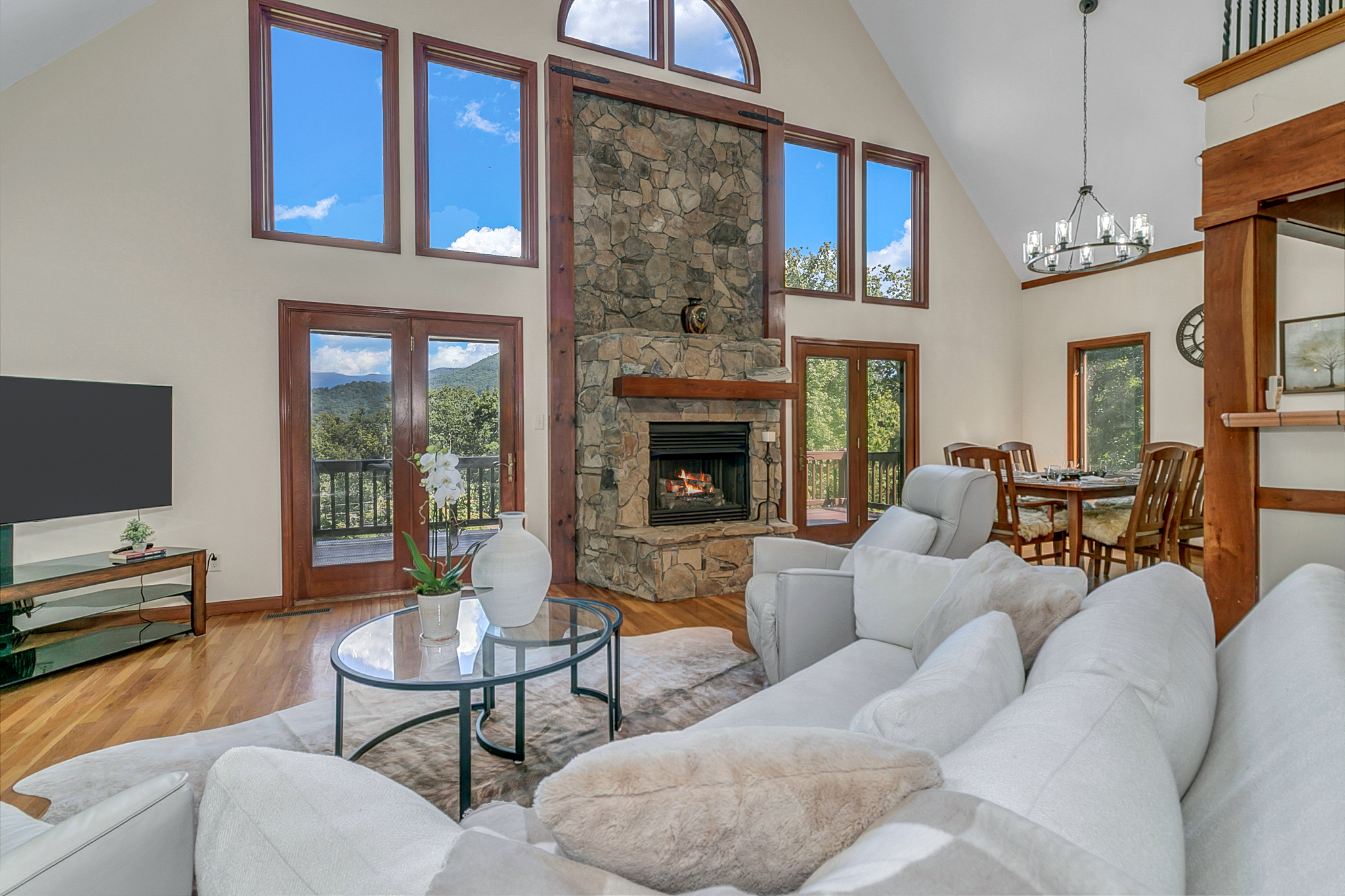 Two-Story Great Room with Stone fireplace, picture windows with mountain views