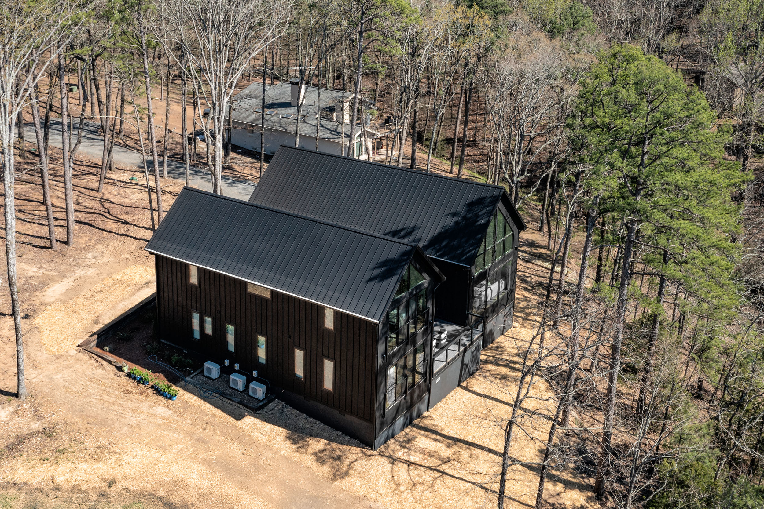 The bold, modern exterior of Sunset Cove blends seamlessly with the natural beauty of the Ozarks—striking, secluded, and surrounded by adventure.