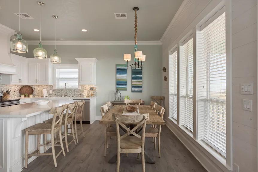 Whip up your favorite meals in this spacious kitchen featuring sleek quartz countertops, rustic wooden seating, and plenty of natural light streaming through large windows.