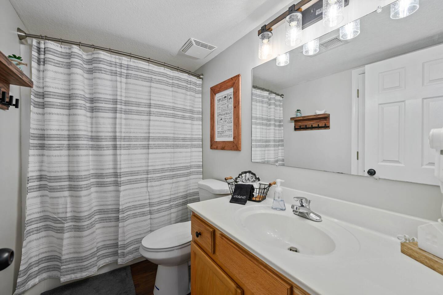 The bathroom has a shower/tub combo. 