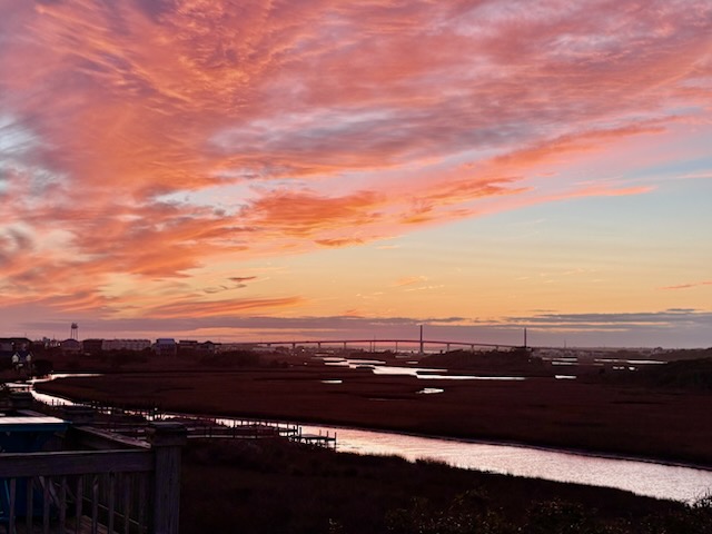 A cotton candy sky at sunset, the Surf City Bridge in the backdrop- did you know at this home you'll have a front row seat to the Independence day firework show right from the balcony?