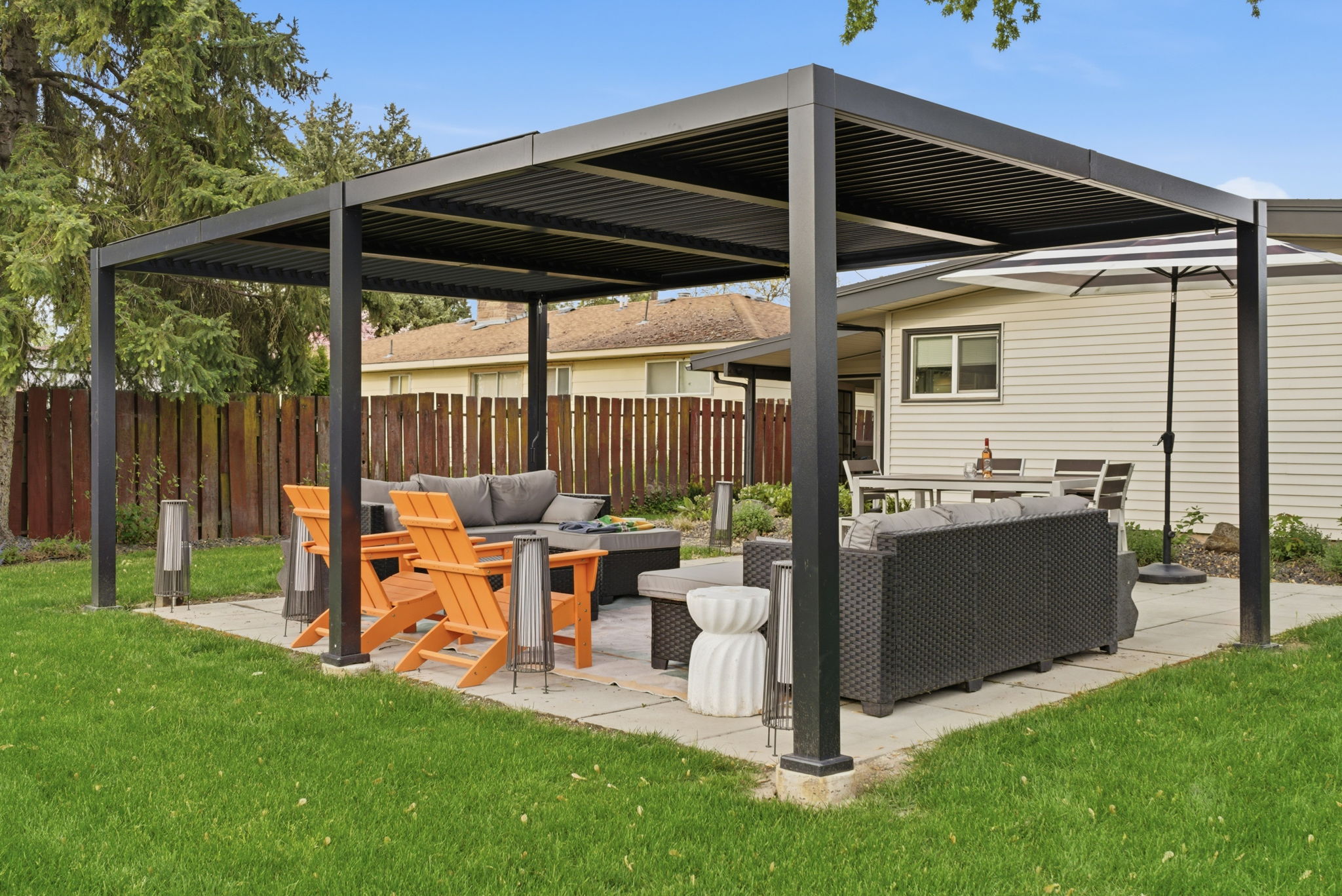 Patio area w/ dining table. covered lounge area.