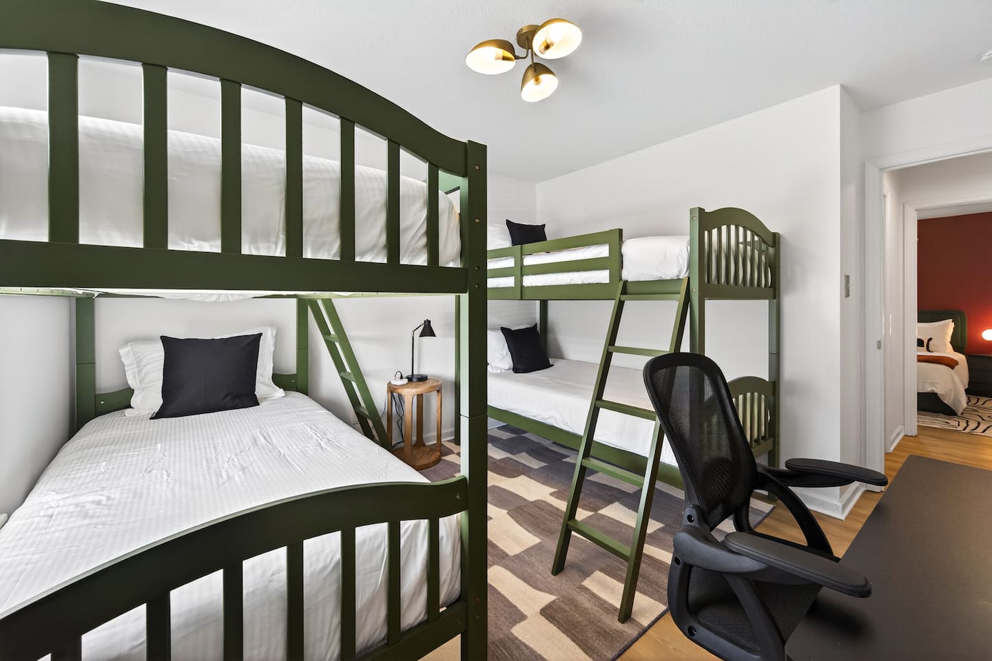 Bunk bedroom with 4 twin beds and a work table +TV