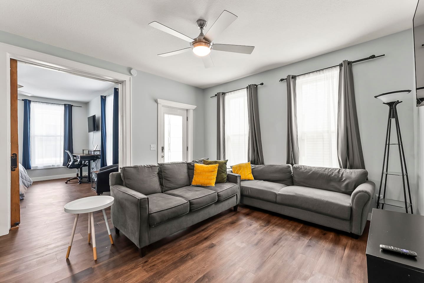Relax in this thoughtfully designed living room featuring comfortable couches, neutral tones, and an open-concept layout.