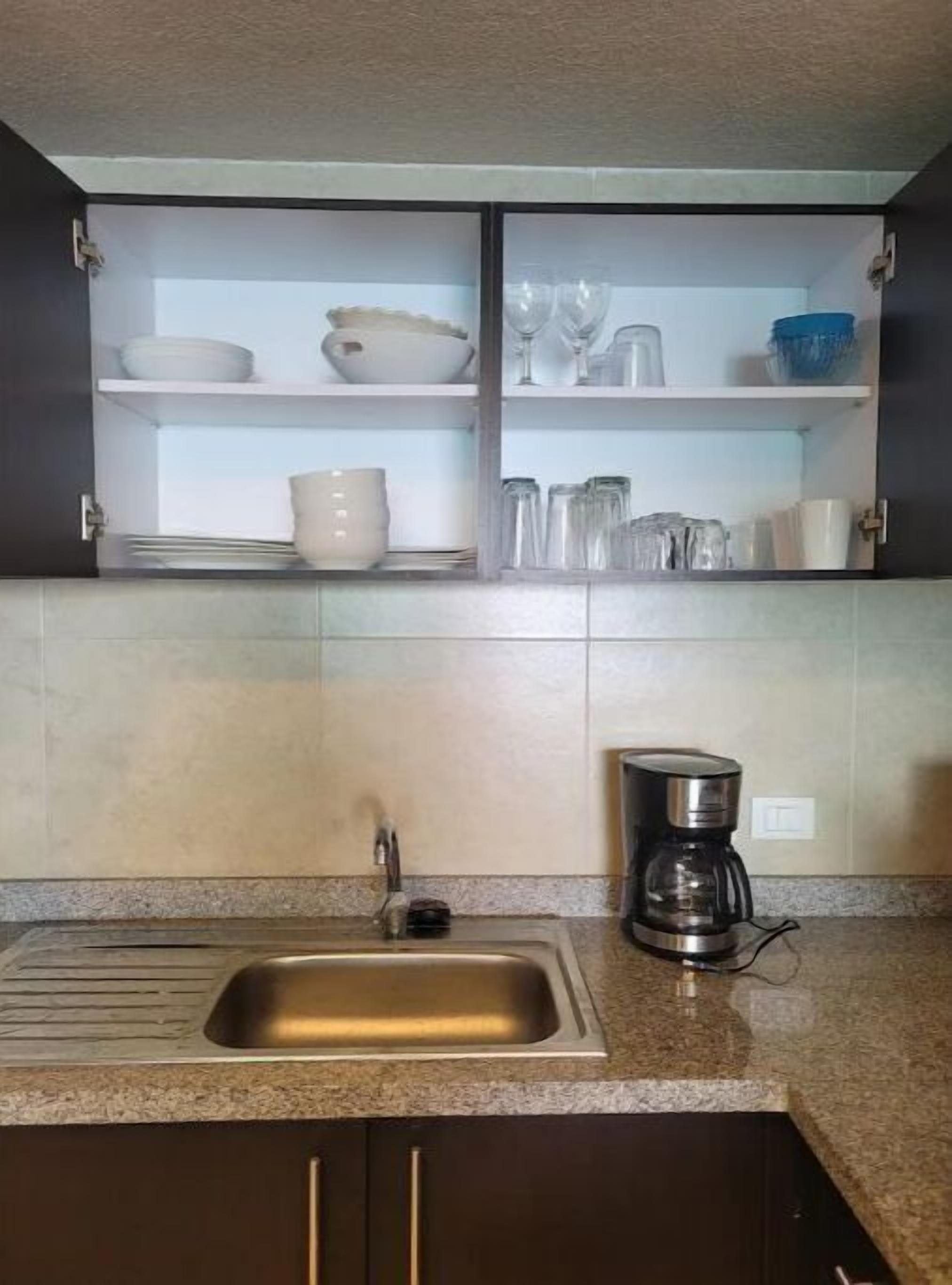 Kitchen is fully stocked with dishes and silverware