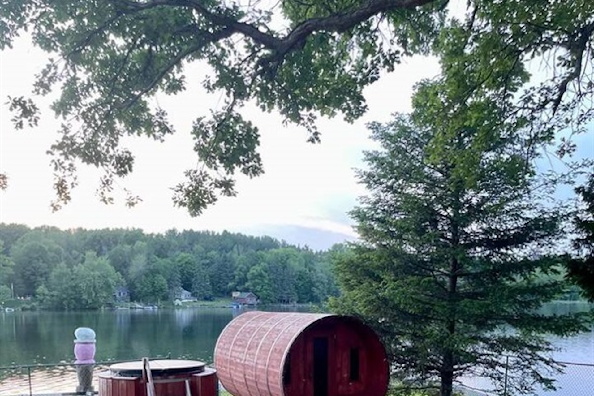 Barrel sauna overlooking the surrounding waterfront setting