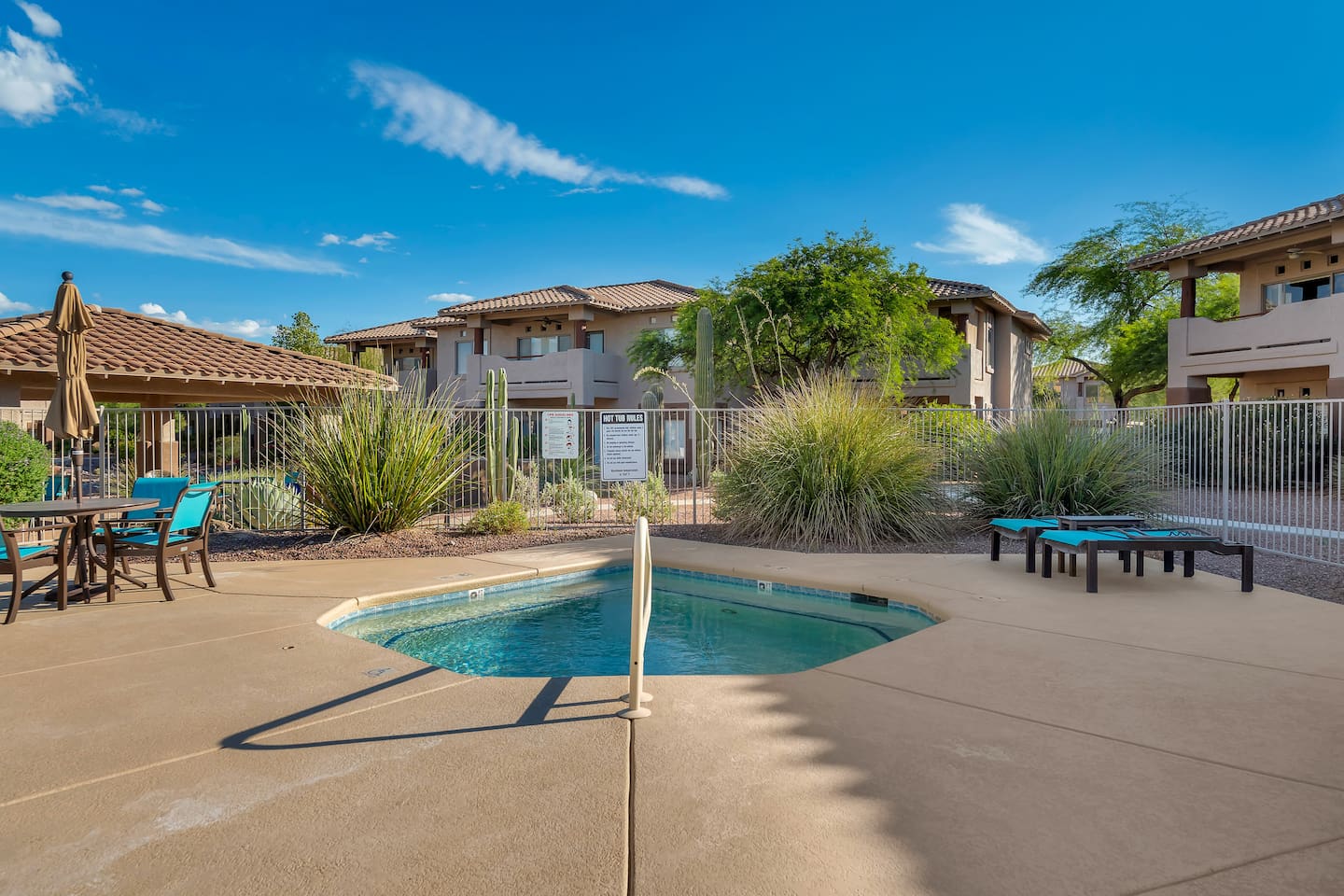 Resort-style community hot-tub with lounge seating