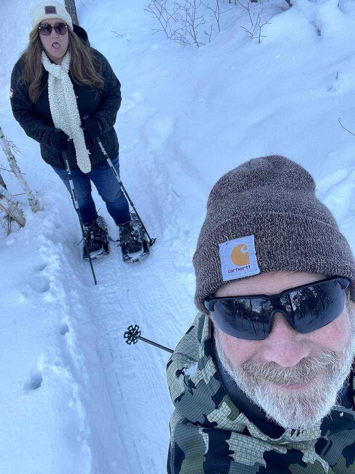 Snowshoeing to groom the fat bike trails