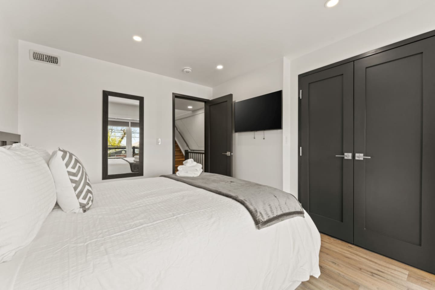 2nd floor queen bedroom with ample closet space and minimalist modern design.