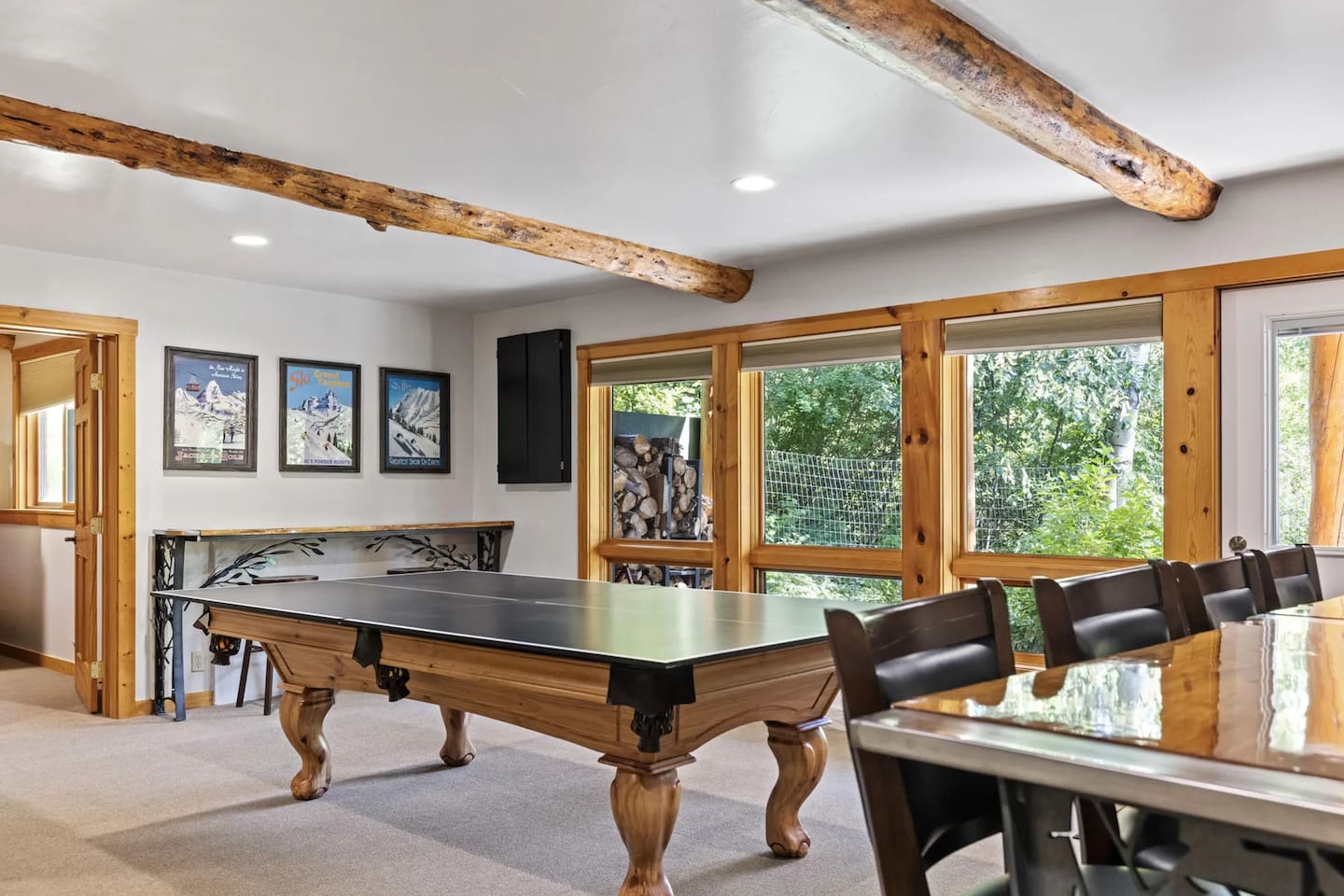Game Room with wood burning fireplace, ping pong, pool, darts, TV and access to patio.