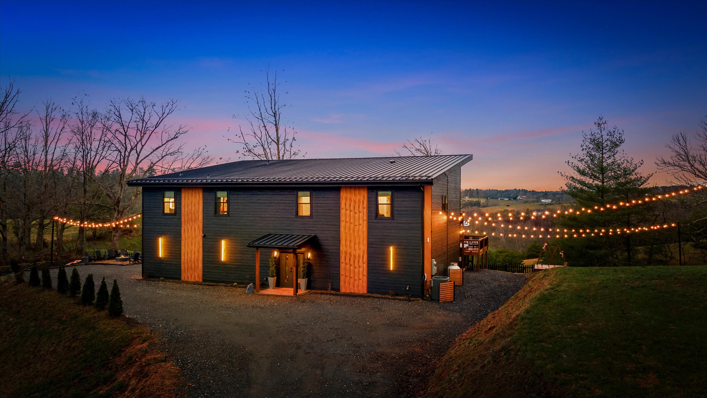 {Exterior Arrival}
Arrive to a private, elevated setting on 2 acres — modern architecture, warm lighting, and a sense of space, with plenty of parking, from the moment you pull in.