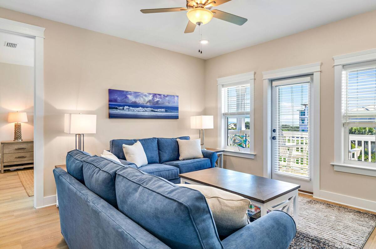 The second-floor living area offers balcony access with breathtaking Gulf views and a queen sleeper sofa, ideal for extra guests or relaxing with the sea breeze.