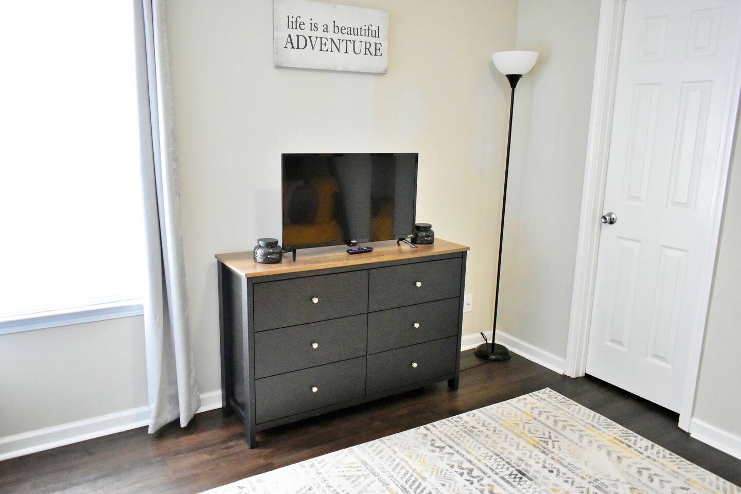 A dresser is provided for storage. The TV is a smart TV.