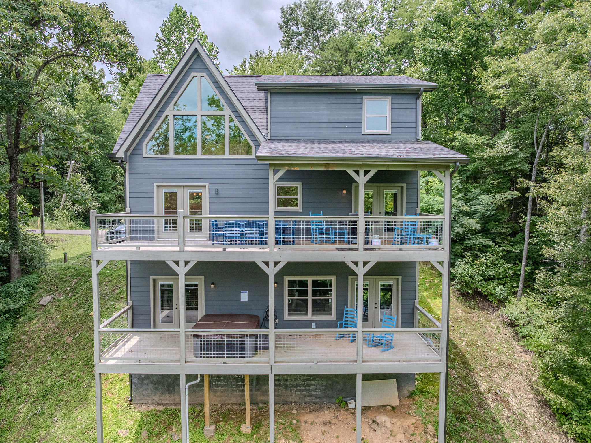 Blue Smoke Outpost sits in a peaceful Sevierville mountain setting surrounded by trees and Smoky Mountain views.