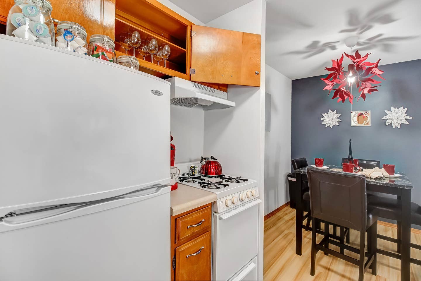 Fridge and stove. Frying pans and a blender. Mixing bowls. Cutting boards.