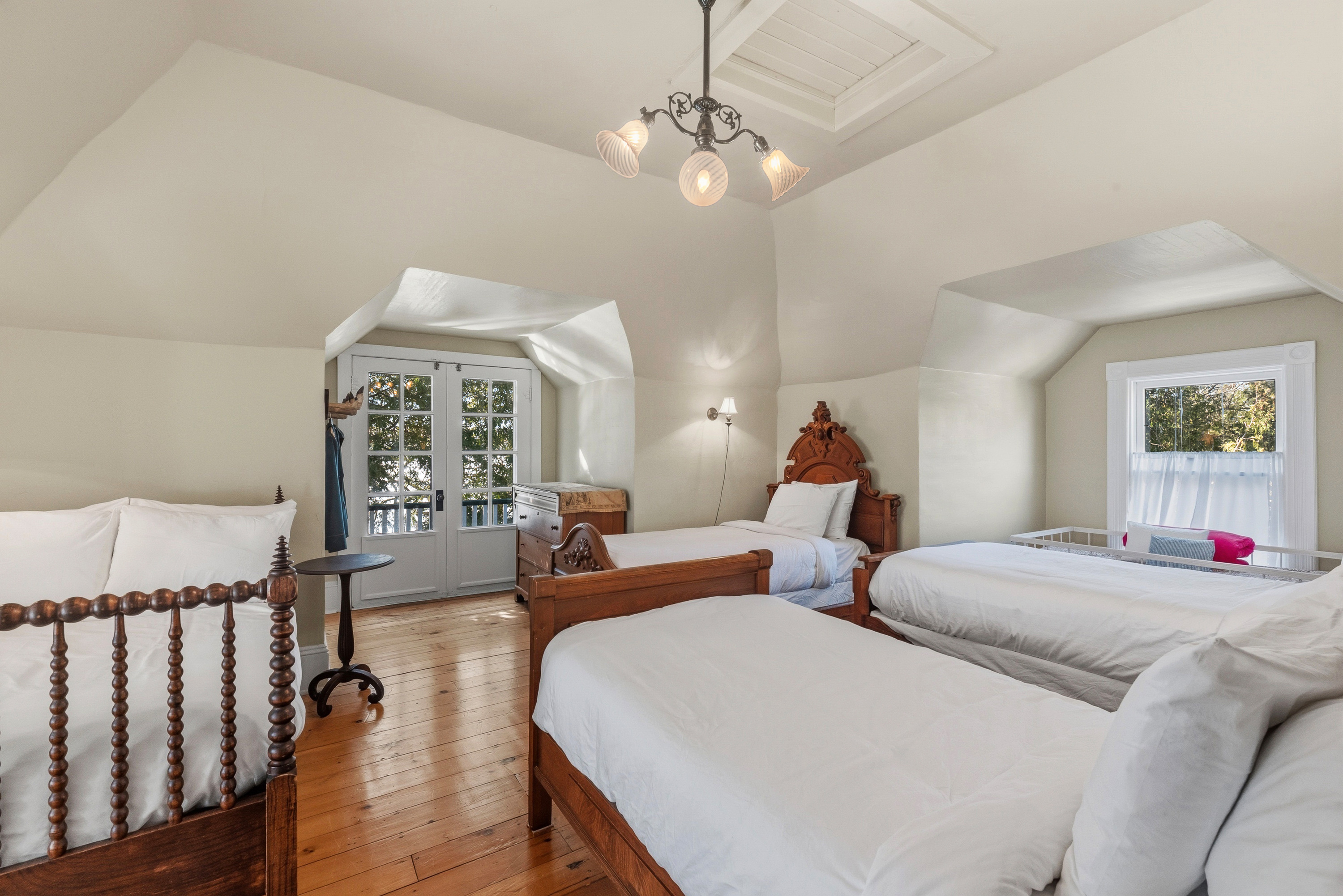 Cozy sleeping porch w/ twin beds & soft natural light