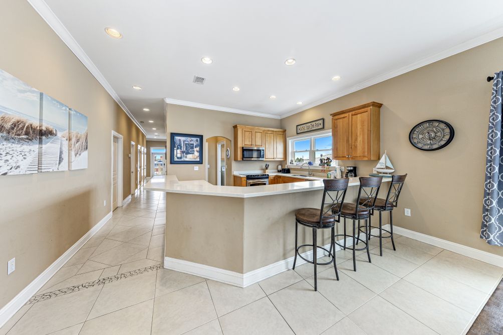 Kitchen breakfast bar with seating for four, open to the main living space