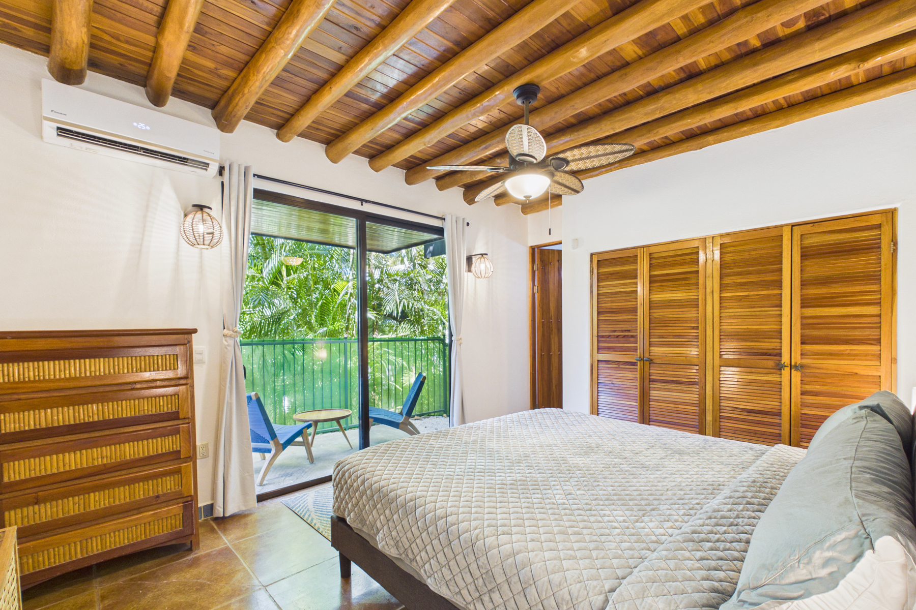 Bedroom 1 with King bed, en suite bathroom, and private patio.  AC