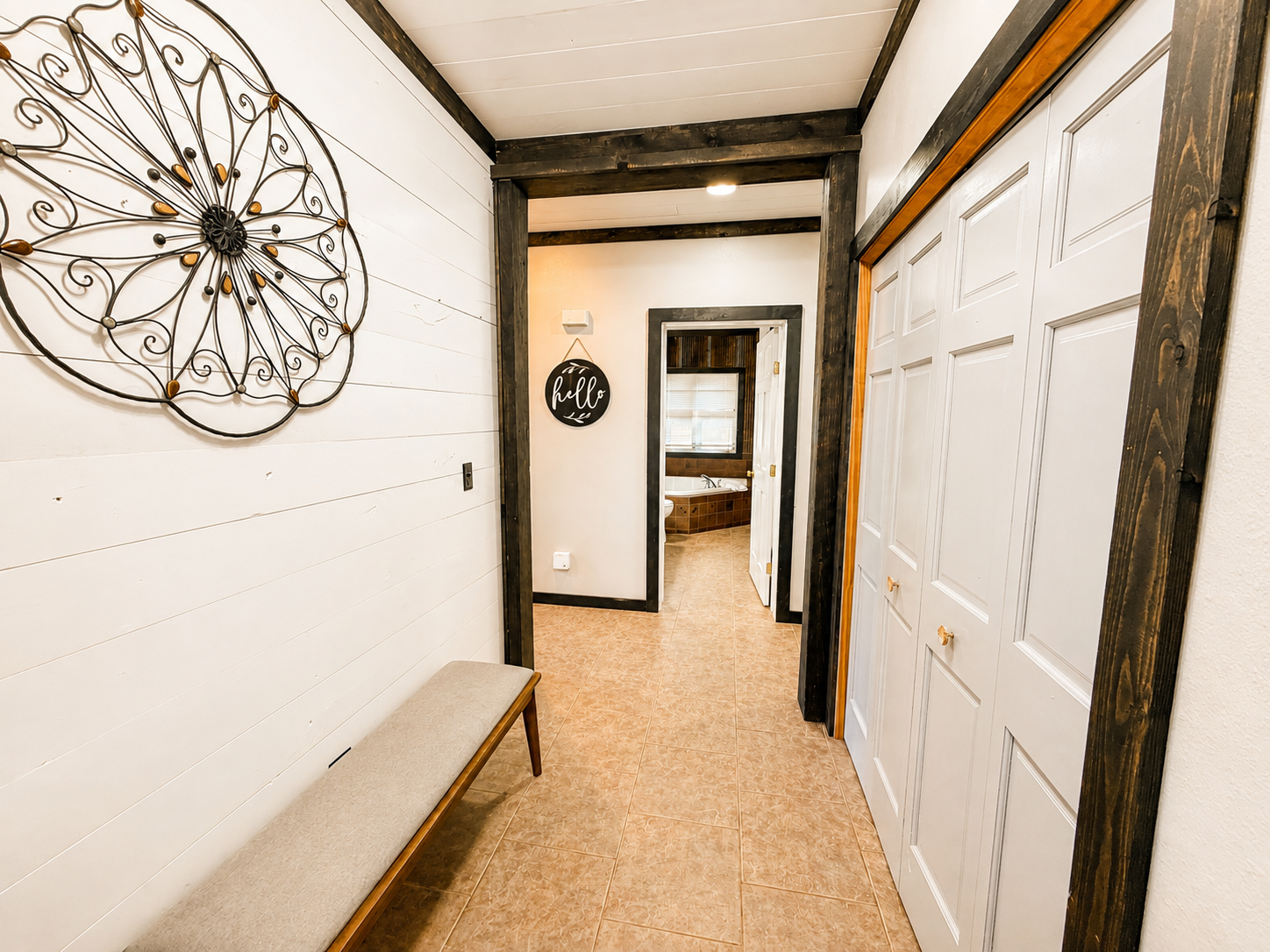 Bright entry hallway with convenient storage connects you to the kitchen, main living room, sleeping spaces and bathroom straight ahead.
