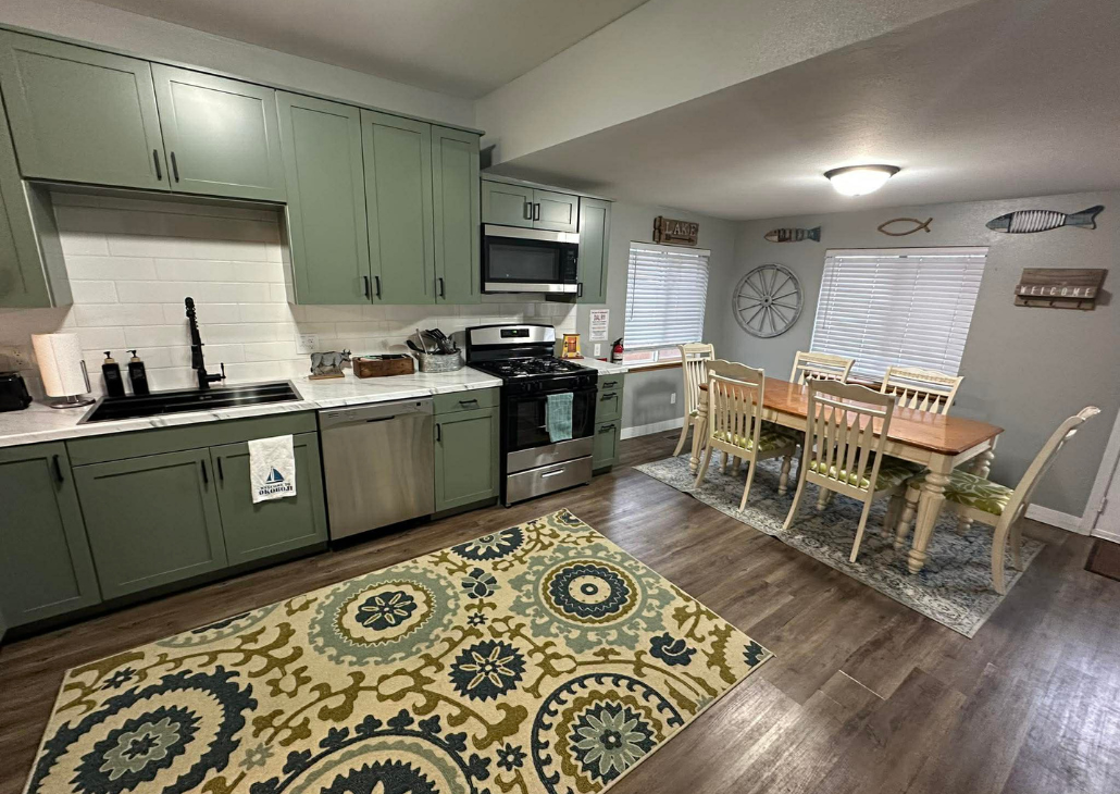 HOUSE WITH WHITE PORCH: this house is family friendly. Open concept so you can see everyone from the front of the house to the back. 