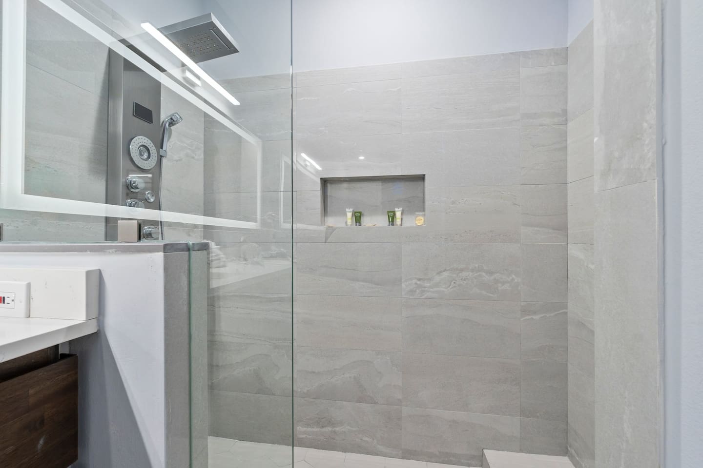 Sleek walk-in shower with glass enclosure, modern tilework, and updated fixtures.