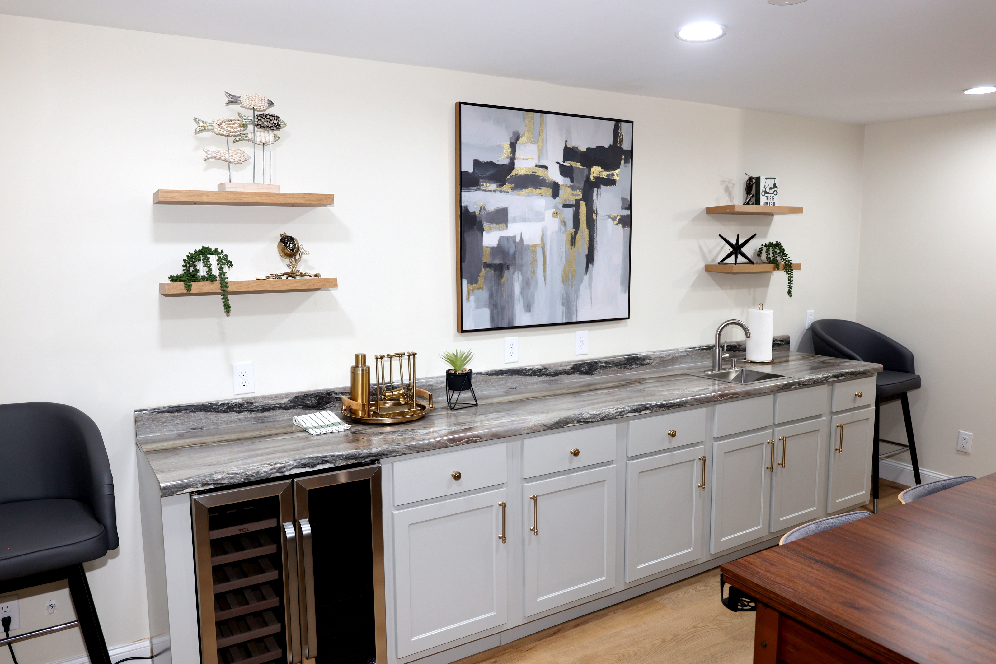 Stylish wet bar and entertainment area with beverage fridge, sink, and modern finishes