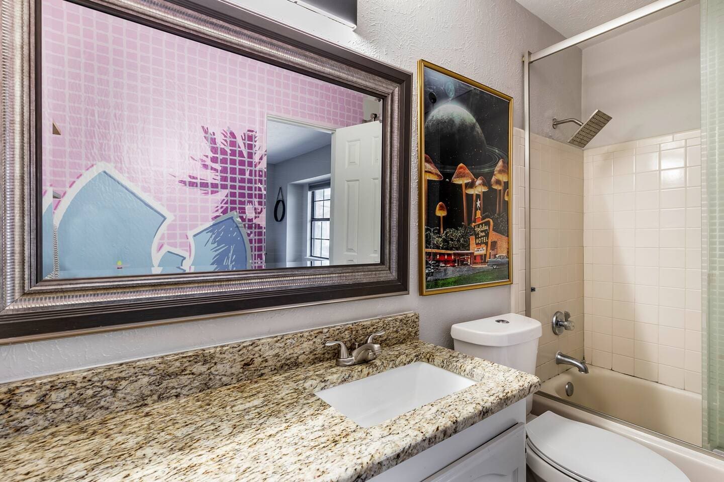 Bathroom with modern vanity and large mirror.
